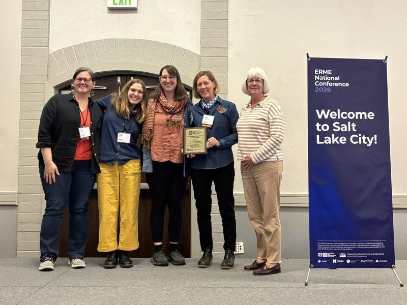 Jennifer Hashley and her team receiving an award from Laurie Wolinski