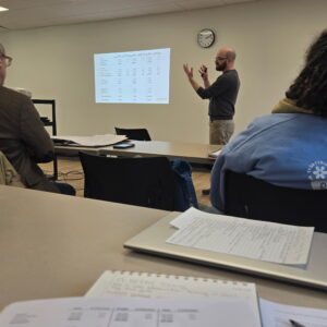 Image of person presenting information in a classroom