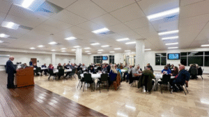 attendees sitting at tables in conference center